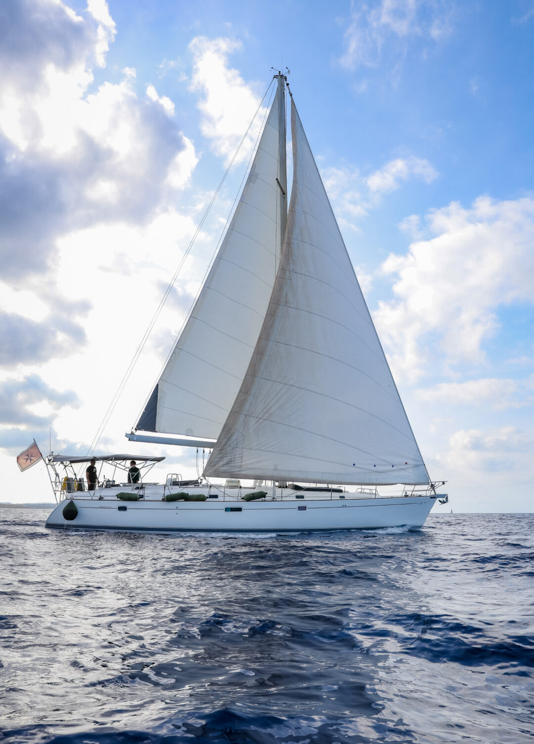 Kanpai sailing yacht anchored near Comino's crystal-clear waters